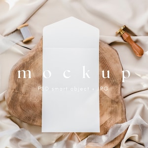 May include: White envelope mockup on a wooden slice with a spool of thread and a wax seal. The text "MOCKUP PSD smart object + JPG" is printed below the envelope.