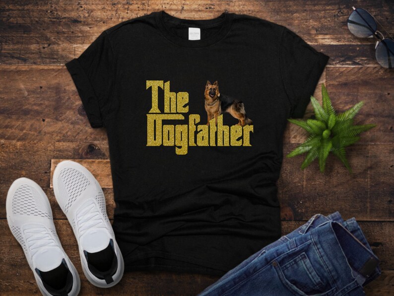 May include: Black t-shirt with gold glitter text that reads "The Dogfather" and a German Shepherd dog image.