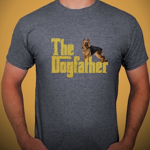 May include: A dark grey t-shirt with a gold glitter design that says "The Dogfather" with a German Shepherd dog standing in front of the text.