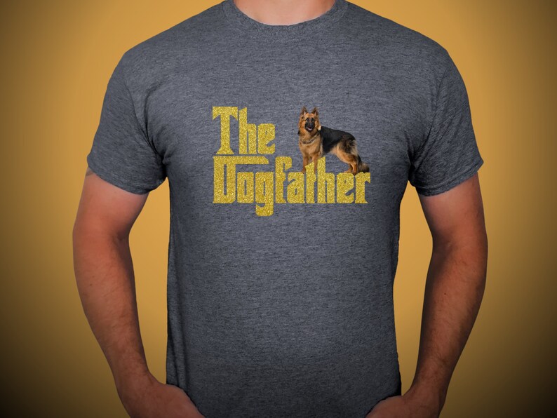 May include: A dark grey t-shirt with a gold glitter design that says "The Dogfather" with a German Shepherd dog standing in front of the text.
