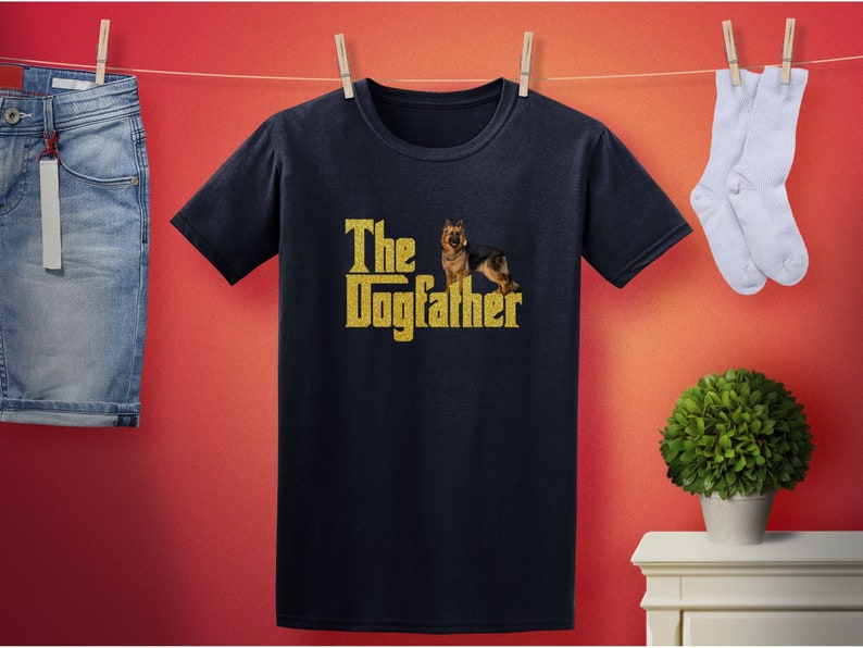 May include: A black t-shirt with a gold graphic of a German Shepherd dog and the text "The Dogfather".