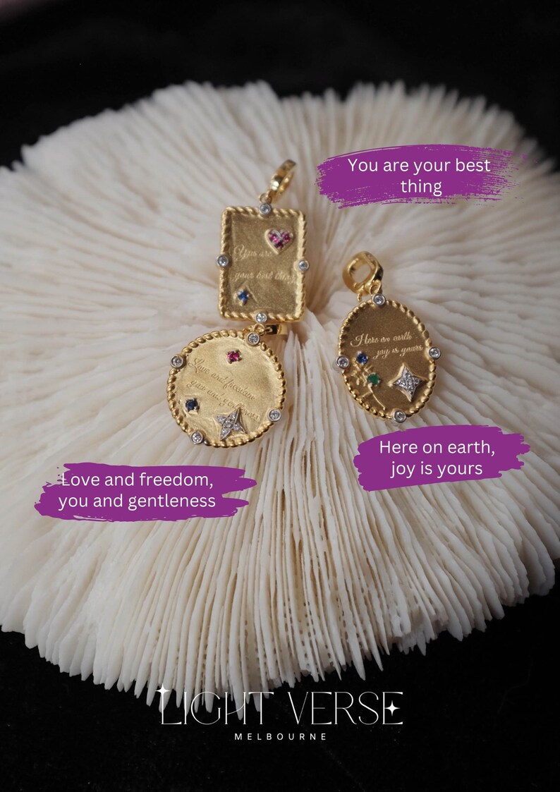 May include: Three gold pendants with colorful gemstones and inspirational messages. The pendants are on a white coral-like surface. The text on the pendants reads: "You are your best thing", "Here on earth joy is yours", and "Love and freedom, you and gentleness". The text "LIGHT VERSE MELBOURNE" is at the bottom of the image.