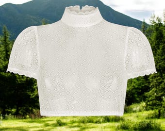 May include: White lace top with a high neck and short sleeves. The lace has a delicate floral pattern.
