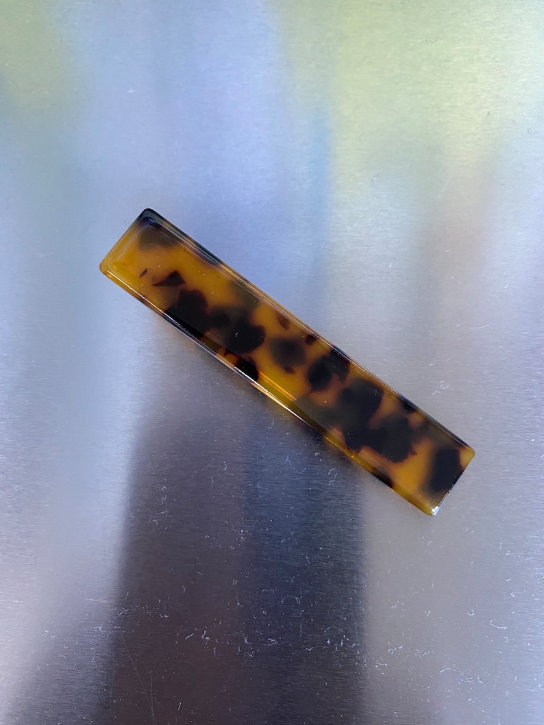 Tortoiseshell Hair slides in glitter acrylic finished.
