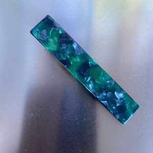 Trendy shimmer hair slides in green pearl textures ready for gifted.