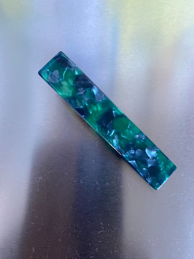 Trendy shimmer hair slides in green pearl textures ready for gifted.