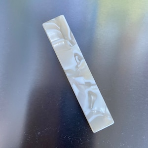 Eco friendly resin hair pins in abstract and natural stone patterns.