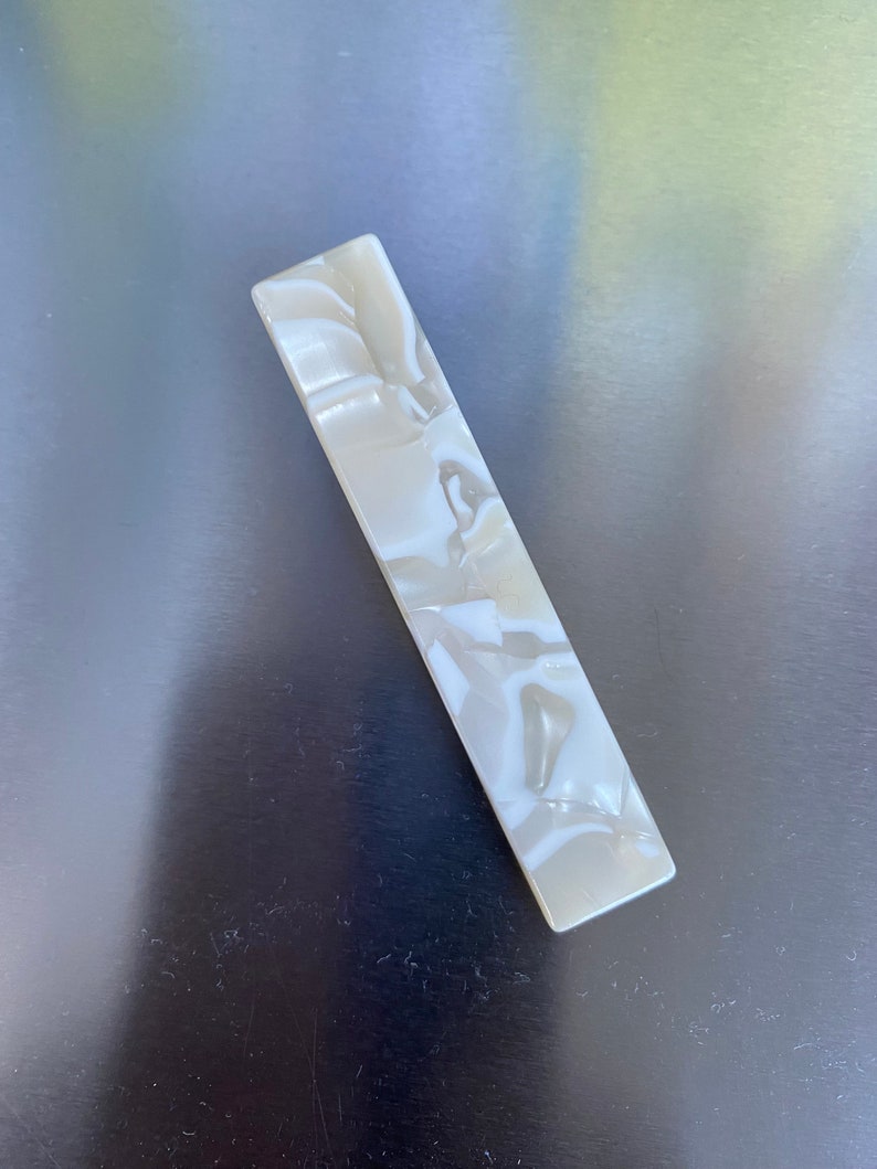 Eco friendly resin hair pins in abstract and natural stone patterns.