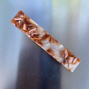 Durable and fashionable resin hair pins in brown.