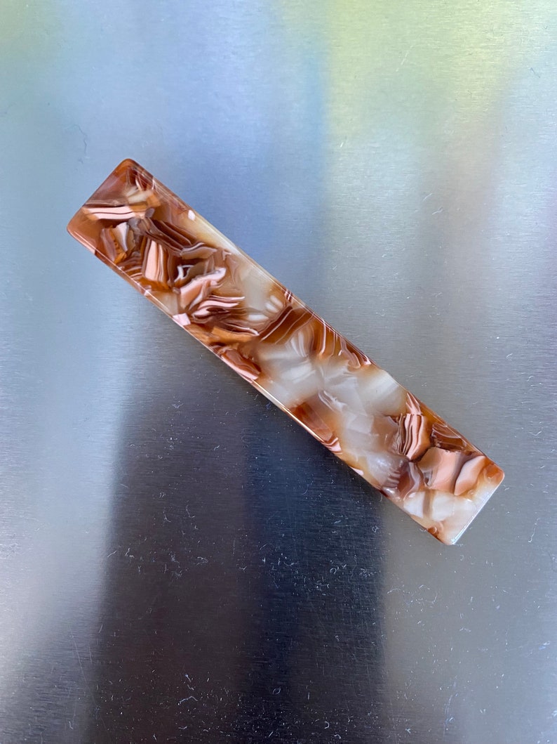 Durable and fashionable resin hair pins in brown.