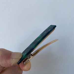 minimalist rectangular acrylic hair clips in unique marbled finishes.