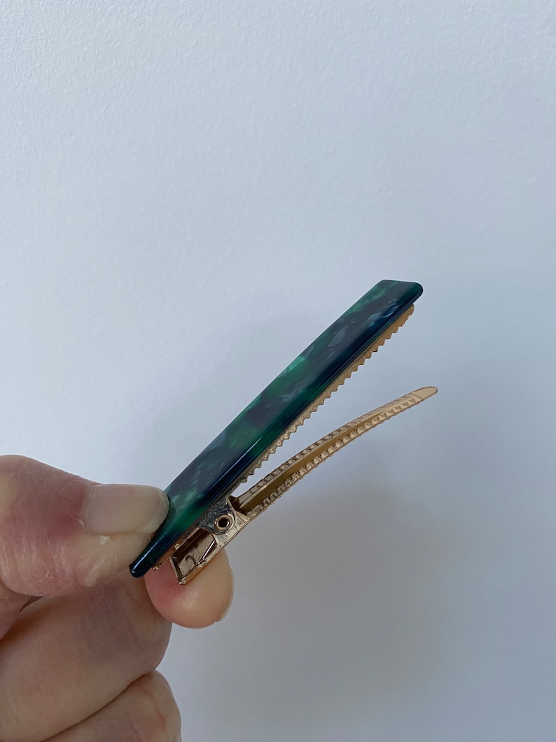minimalist rectangular acrylic hair clips in unique marbled finishes.