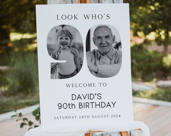 May include: A white welcome sign with black text that reads "Look Who's 90! Welcome to David's 90th Birthday, Saturday 24th August 2024". The number 90 is made up of two black and white photos of a young boy and an older man.