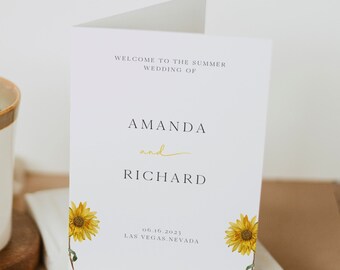 May include: A white wedding invitation with a sunflower design. The invitation reads "Welcome to the Summer Wedding of Amanda and Richard" and includes the date "06.16.2023" and location "Las Vegas, Nevada".