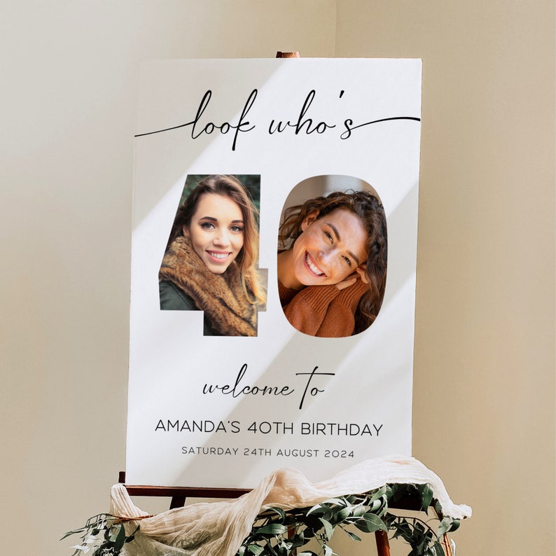 May include: A white sign with the text "look who's" in a cursive font, and the number "40" with two photos inside. Below, it reads "welcome to AMANDA'S 40TH BIRTHDAY SATURDAY 24TH AUGUST 2024". The sign is on an easel.
