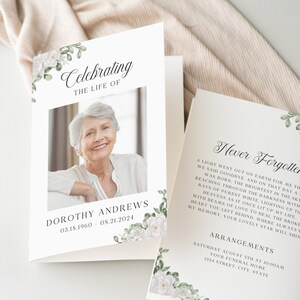 May include: A white card with a floral border and a photograph of a woman. The text "Celebrating the Life of Dorothy Andrews 03.18.1960 - 08.21.2024" is printed on the card. The back of the card has a poem titled "Never Forgotten" and details about funeral arrangements.