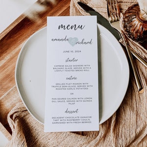 May include: A light blue menu card with the text "menu" in a cursive font. The names "amanda & richard" are written below the word "menu" with a heart symbol between the names. The date "JUNE 10, 2024" is printed below the names. The menu lists "starter", "entrée", and "dessert" options.