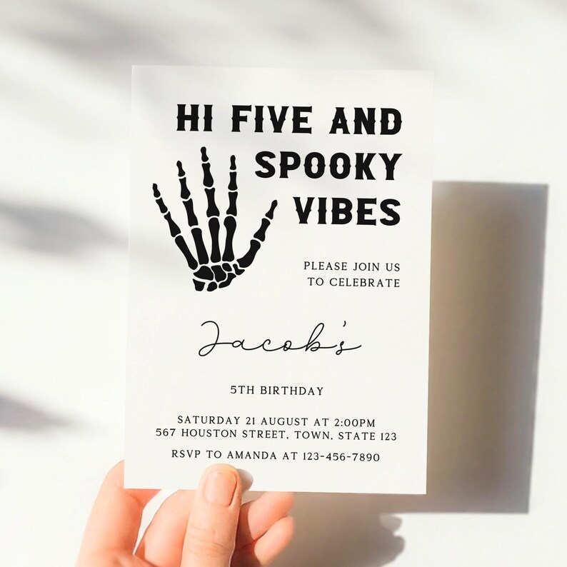 May include: Black and white invitation with a skeleton hand graphic. The text reads "Hi Five and Spooky Vibes" and "Jacob's 5th Birthday". The invitation includes details for a birthday party on August 21st at 2:00 PM.