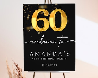 May include: A black sign on an easel with gold text and confetti. The sign reads "60 welcome to AMANDA'S 60th BIRTHDAY PARTY 12.06.2024". The number 60 is in a gold, 3D font.