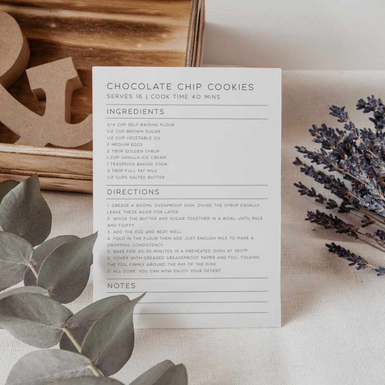 May include: A printable recipe card for chocolate chip cookies. The recipe card is printed on white paper with gray text. The recipe includes ingredients such as self-raising flour, brown sugar, vegetable oil, eggs, golden syrup, vanilla ice cream, baking soda, milk, and salted butter. The recipe also includes directions for making the cookies.