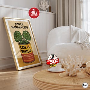 May include: A framed vertical wall art print featuring a yellow and red Cafe Bustelo coffee can with a green monstera plant growing out of the top. The text reads POR LA MA&Ntilde;ANA CAFE, CAFE BUSTELO, SIEMPRE FRESCO, PURO Y AROMATICO COMO NINGUNO, PESO NETO 10 OZ.