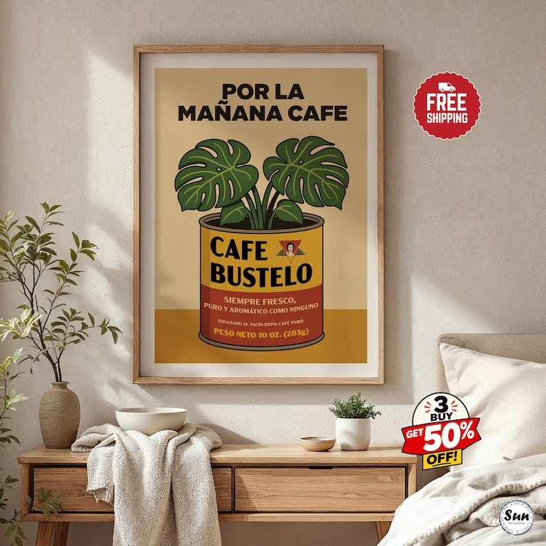 May include: A framed wall art print featuring a graphic illustration of a Cafe Bustelo coffee can with a monstera plant growing out of the top. The text reads POR LA MA&Ntilde;ANA CAFE, CAFE BUSTELO, SIEMPRE FRESCO, PURO Y AROMATICO COMO NINGUNO, PESO NETO 10 OZ. (283G).