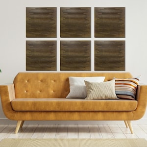 May include: Six brown wood acoustic panels with a geometric pattern are arranged in a grid on a white wall above a brown leather sofa with two throw pillows.