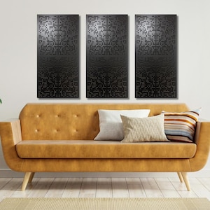 May include: Three black and white abstract wall art panels with a geometric pattern hang above a brown leather sofa with throw pillows.