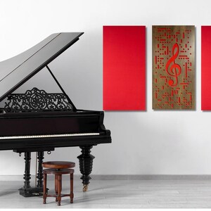 May include: A black grand piano with a red and brown treble clef wall art. The piano has a carved wooden design on the soundboard and ornate legs. A music stand with a lyre design is in the background.