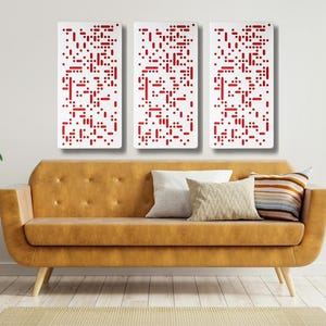 May include: Three white rectangular wall panels with a red geometric pattern. The panels are hanging on a white wall above a brown couch with white and striped throw pillows.