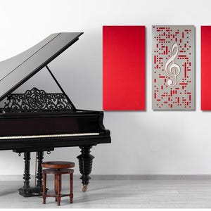May include: A black grand piano with the lid open, a red and white musical note wall decor, and a music stand with a lyre.