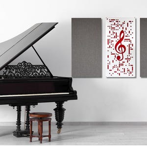 May include: A grand piano with a black finish and ornate detailing, set against a white wall. A decorative music stand and a stool are in front of the piano. A wall art piece with a red treble clef is also present.