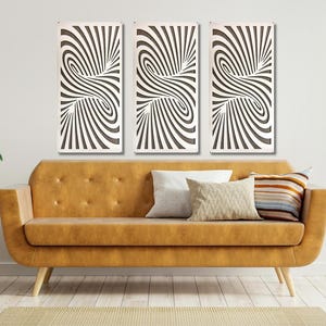 May include: Three black and white abstract wall art panels with a swirling pattern. The panels are hanging on a white wall above a brown leather couch with pillows.