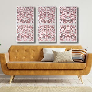 May include: Three white rectangular wall panels with a red pixelated pattern. The panels are hanging on a white wall above a brown couch with white throw pillows.