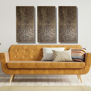 May include: Three rectangular wall panels with a geometric pattern of small holes. The panels are a light brown color and are hanging on a white wall above a brown couch.