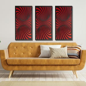 May include: Three abstract wall art panels with a swirling black and red design. The panels are hanging on a white wall above a brown couch.