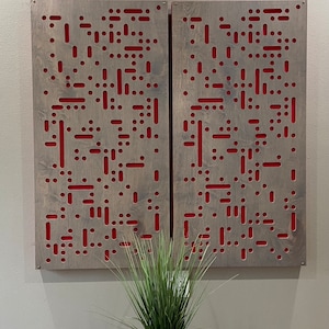 May include: Two gray wood panels with a red geometric pattern cut out. The panels are mounted on a wall.