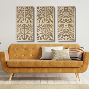 May include: Three rectangular wooden wall panels with a geometric pattern of small holes. The panels are arranged horizontally on a white wall above a brown couch with pillows.