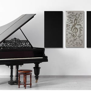May include: A black grand piano with an open lid, a music stand with a treble clef, and two black acoustic panels on the wall. One panel has a treble clef design.