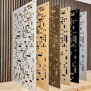 May include: Six decorative panels with a geometric pattern of holes. The panels are made of different materials, including wood and metal. The panels are arranged in a row, with the lightest panel on the left and the darkest panel on the right.