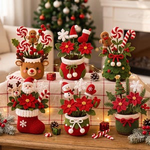 May include: A collection of six crocheted Christmas-themed potted arrangements featuring various figures including a reindeer, Santa Claus, a snowman, gingerbread men, candy canes, poinsettias, snowflakes, and stockings in red, green, and white.