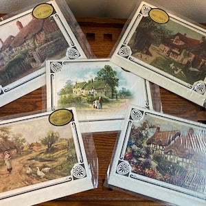 May include: A collection of antique postcards, each depicting a rural landscape scene with thatched-roof cottages and country roads. The postcards are packaged in clear plastic and feature a decorative border and the text "Antique Post Cards 1907-1920's".