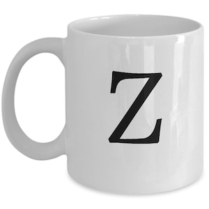 Op de afbeelding: Witte keramische koffiemok met een zwarte letter Z gedrukt op de voorkant.