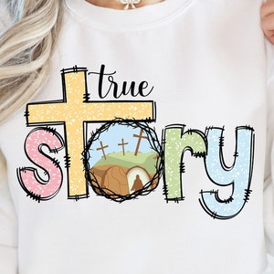 May include: White sweatshirt with a colorful graphic design that says "true story" with a cross and a tomb with a rolling stone.
