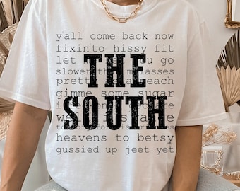May include: White t-shirt with black text that reads "y'all come back now fixin' to hissy fit let the masses slower than each gimme some sugar  i'm proud to be from the south".