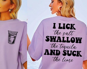 May include: A purple t-shirt with a graphic on the back that says "I lick the salt, swallow the tequila and suck the lime". The front of the shirt has a graphic of a shot glass with a lime wedge.