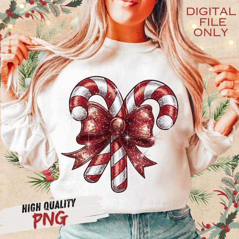 Op de afbeelding: Wit sweatshirt met een feestelijk zuurstokontwerp met rood-witte strepen en een glinsterende rode strik. De tekst "DIGITAL FILE ONLY" en "HIGH QUALITY PNG" zijn ook zichtbaar.