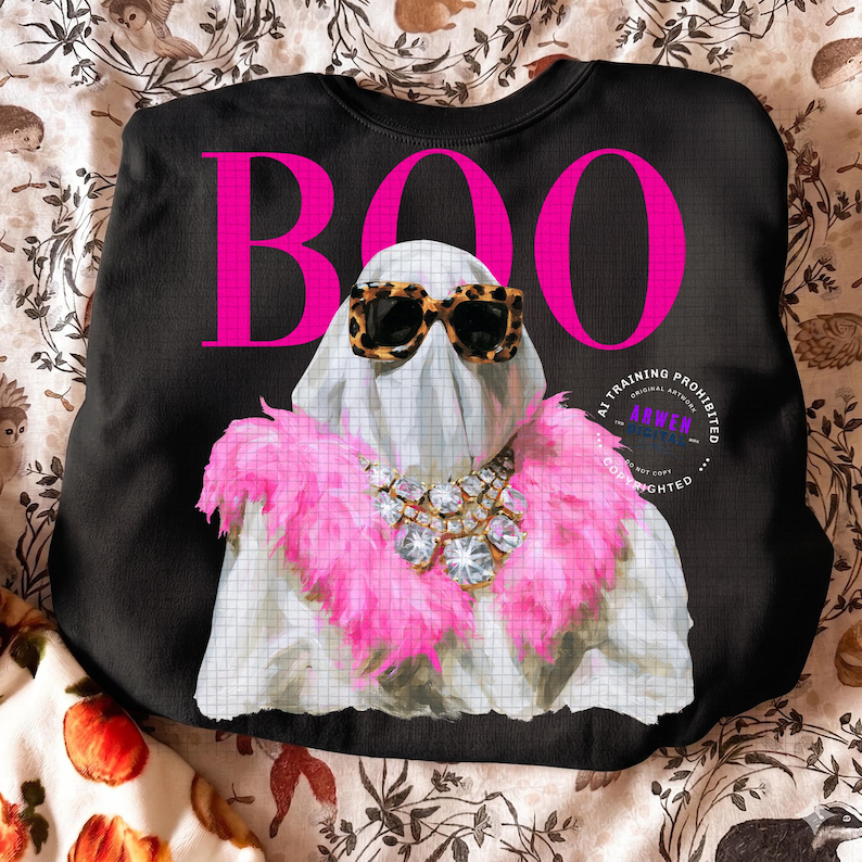 May include: A black sweatshirt featuring a large pink graphic of a ghost wearing leopard print sunglasses and a pink feather boa with a crystal statement necklace. The word BOO is printed in large pink letters above the ghost figure.