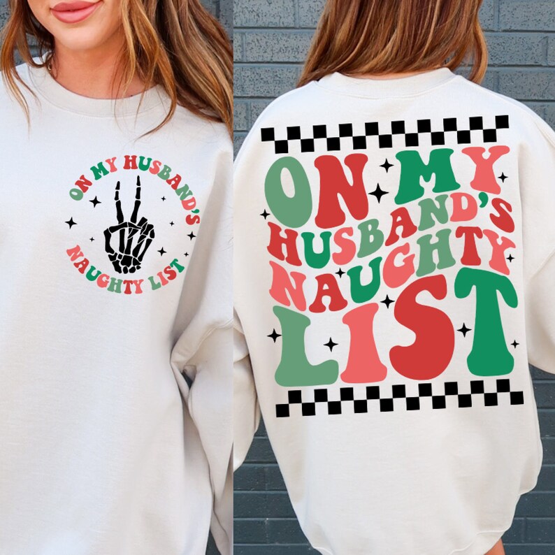 May include: Off-white sweatshirt with the text "ON MY HUSBAND'S NAUGHTY LIST" in a retro font. The front features a skeleton hand making a peace sign. The back has the same text in a larger format with a checkered pattern.