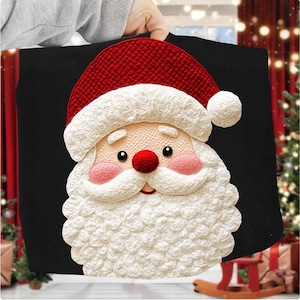May include: Black tote bag with a detailed Santa Claus face. The Santa has a red hat, rosy cheeks, a white beard, and a red nose. The design is made with a textured, knitted appearance, ideal for Christmas gifts.